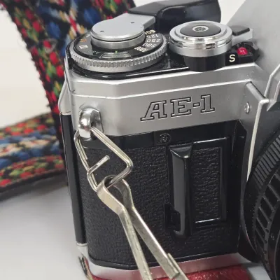 LOT 42: Vintage Canon AE-1 35mm SLR Film Camera with Telephoto Zoom Lense and Strap