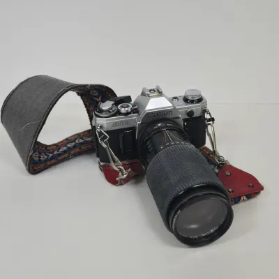 LOT 42: Vintage Canon AE-1 35mm SLR Film Camera with Telephoto Zoom Lense and Strap