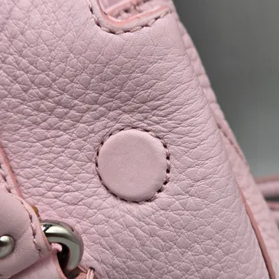 LOT 142: Pink Pebbled Leather Handbag from the Cole Haan Village Collection