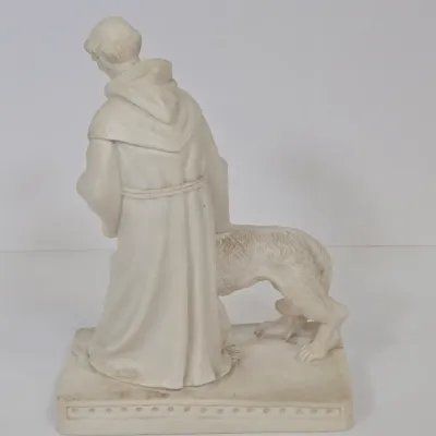 LOT 51: White Devotional Statue of Saint Francis of Assisi Taming the Wolf of Gubbio and Replica Figurine of Michelangelo's Pietà,...