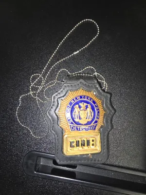 Sale Photo Thumbnail #112: This item is a replica or prop badge, specifically identified as the NYPD Detective badge for the character Bobby Simone from the television show NYPD Blue.