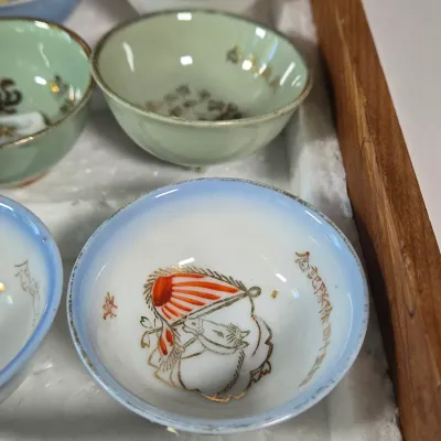 LOT 132F: Large Collection of Antique Japanese Military Sake Cups, Four Sake Bottles, and Beautiful Wood Chest for Storage