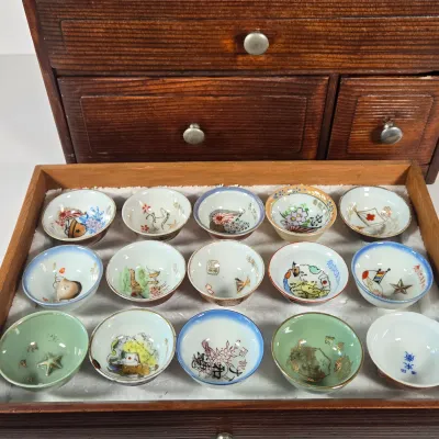 LOT 132F: Large Collection of Antique Japanese Military Sake Cups, Four Sake Bottles, and Beautiful Wood Chest for Storage