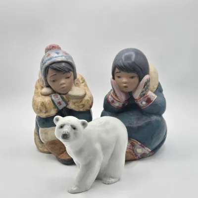 LOT 47L: Lladró "Pensive Eskimo Boy", "Pensive Eskimo Girl" Figurines, and "Attentive Polar Bear" Figurine