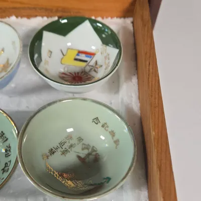 LOT 132F: Large Collection of Antique Japanese Military Sake Cups, Four Sake Bottles, and Beautiful Wood Chest for Storage