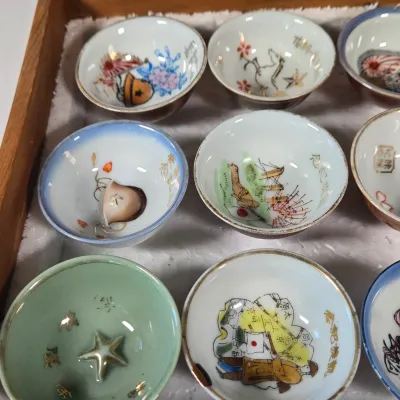 LOT 132F: Large Collection of Antique Japanese Military Sake Cups, Four Sake Bottles, and Beautiful Wood Chest for Storage