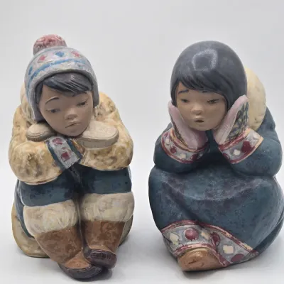 LOT 47L: Lladró "Pensive Eskimo Boy", "Pensive Eskimo Girl" Figurines, and "Attentive Polar Bear" Figurine
