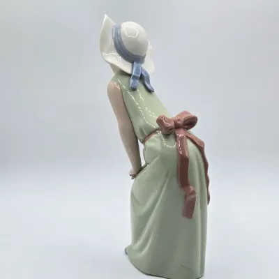 LOT 40L: Retired Lladró "Curious Girl with Straw Hat" Porcelain Figurine