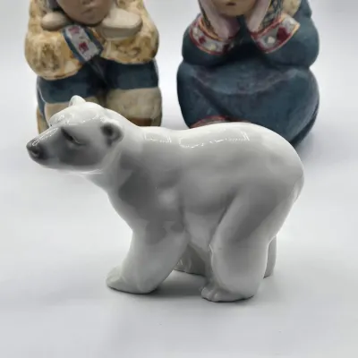 LOT 47L: Lladró "Pensive Eskimo Boy", "Pensive Eskimo Girl" Figurines, and "Attentive Polar Bear" Figurine