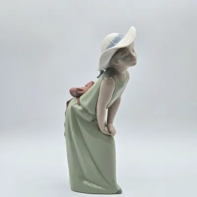 LOT 40L: Retired Lladró "Curious Girl with Straw Hat" Porcelain Figurine