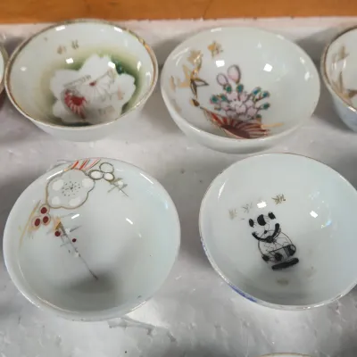 LOT 132F: Large Collection of Antique Japanese Military Sake Cups, Four Sake Bottles, and Beautiful Wood Chest for Storage