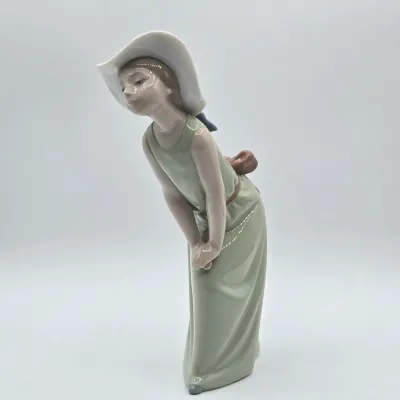 LOT 40L: Retired Lladró "Curious Girl with Straw Hat" Porcelain Figurine
