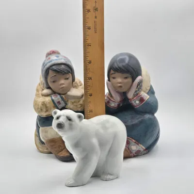 LOT 47L: Lladró "Pensive Eskimo Boy", "Pensive Eskimo Girl" Figurines, and "Attentive Polar Bear" Figurine