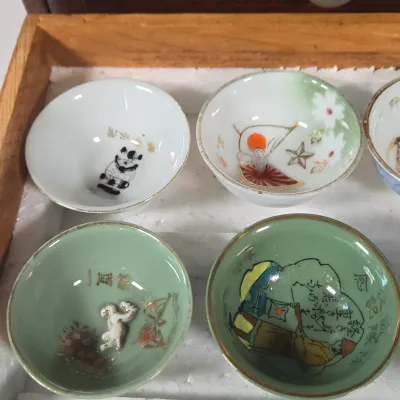 LOT 132F: Large Collection of Antique Japanese Military Sake Cups, Four Sake Bottles, and Beautiful Wood Chest for Storage