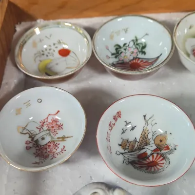 LOT 132F: Large Collection of Antique Japanese Military Sake Cups, Four Sake Bottles, and Beautiful Wood Chest for Storage