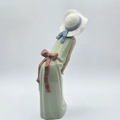 LOT 40L: Retired Lladró "Curious Girl with Straw Hat" Porcelain Figurine