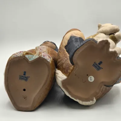 LOT 46L: Lladro "Artic Winter Girl" and "Poor Little Bear" Figurines