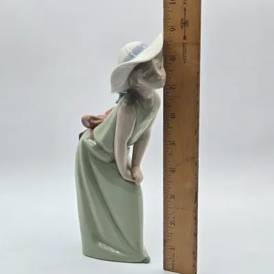 LOT 40L: Retired Lladró "Curious Girl with Straw Hat" Porcelain Figurine