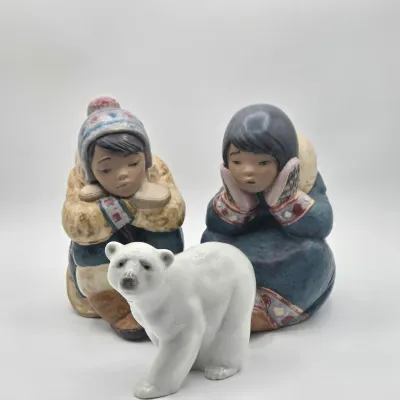 LOT 47L: Lladró "Pensive Eskimo Boy", "Pensive Eskimo Girl" Figurines, and "Attentive Polar Bear" Figurine