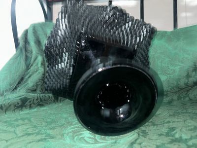 Sale Photo Thumbnail #635: VINTAGE BLACK AMETHYST GLASS COMPOTE PEDESTAL BOWL WITH FOUR MATCHING HOBNAIL/DIAMOND POINT TUMBLERS. FEATURES A TEXTURED GEOMETRIC PATTERN AND STARBURST BASE DETAILS. LIGHT WEAR FROM USE, NO VISIBLE CHIPS OR CRACKS.
