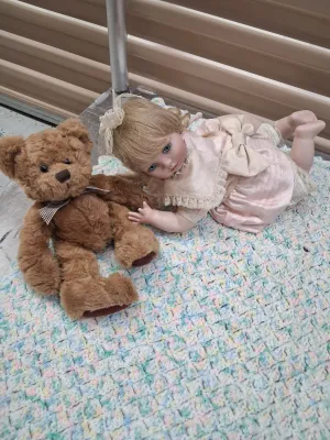Sale Photo Thumbnail #484: PORCELAIN BABY DOLL IN PINK DRESS, RUSS BERRIE LANGLEY TEDDY BEAR, DEPARTMENT 50 TED D. BEAR PLUSH, ADDITIONAL TEDDY BEAR, AND CROCHETED BABY BLANKET. ALL ITEMS ARE IN PRE-OWNED CONDITION WITH NO VISIBLE MAJOR DAMAGE.