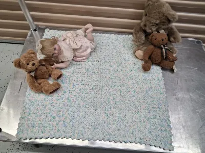 Sale Photo Thumbnail #483: PORCELAIN BABY DOLL IN PINK DRESS, RUSS BERRIE LANGLEY TEDDY BEAR, DEPARTMENT 50 TED D. BEAR PLUSH, ADDITIONAL TEDDY BEAR, AND CROCHETED BABY BLANKET. ALL ITEMS ARE IN PRE-OWNED CONDITION WITH NO VISIBLE MAJOR DAMAGE.