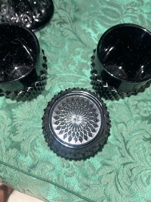 Sale Photo Thumbnail #630: VINTAGE BLACK AMETHYST GLASS COMPOTE PEDESTAL BOWL WITH FOUR MATCHING HOBNAIL/DIAMOND POINT TUMBLERS. FEATURES A TEXTURED GEOMETRIC PATTERN AND STARBURST BASE DETAILS. LIGHT WEAR FROM USE, NO VISIBLE CHIPS OR CRACKS.