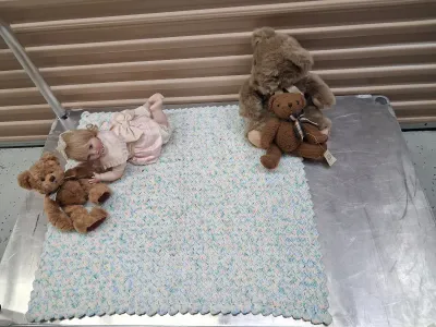 Sale Photo Thumbnail #485: PORCELAIN BABY DOLL IN PINK DRESS, RUSS BERRIE LANGLEY TEDDY BEAR, DEPARTMENT 50 TED D. BEAR PLUSH, ADDITIONAL TEDDY BEAR, AND CROCHETED BABY BLANKET. ALL ITEMS ARE IN PRE-OWNED CONDITION WITH NO VISIBLE MAJOR DAMAGE.