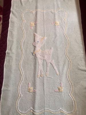 Sale Photo Thumbnail #1152: 38”x65” Blue vintage cotton chenille baby crib blanket or coverlet featuring a tufted white fawn or deer design in the center with pastel floral accents