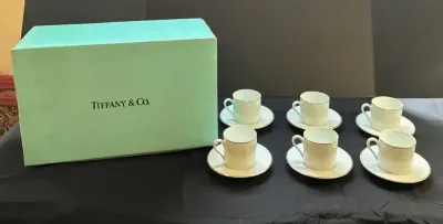 Tiffany & Co. white porcelain demitasse cups and saucers detailed with a clean gold rim