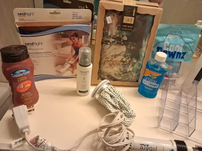 NEW HELEN OF TROY BRUSH IRON, NEW HOT/COLD TUMMY PILLOW, TOILETRIES, SEAL TIGHT CAST/BANDAGE PROTECTOR