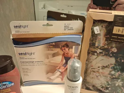 NEW HELEN OF TROY BRUSH IRON, NEW HOT/COLD TUMMY PILLOW, TOILETRIES, SEAL TIGHT CAST/BANDAGE PROTECTOR