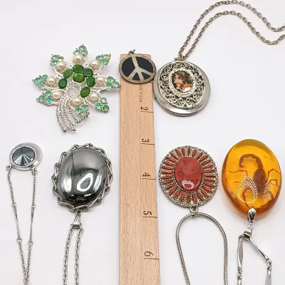 LOT 111: Faux Amber-Incased Scorpion Pendant on a Sarah Coventry Chain, Sarah Coventry Hematite Necklace & More