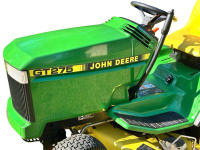 Sale Photo Thumbnail #148: John Deere GT275 Garden Tractor with a Yellow seat, a Mower deck, and Extra Wheel