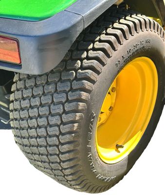Sale Photo Thumbnail #161: John Deere GT275 Garden Tractor with a Yellow seat, a Mower deck, and Extra Wheel