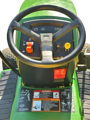 Sale Photo Thumbnail #156: John Deere GT275 Garden Tractor with a Yellow seat, a Mower deck, and Extra Wheel