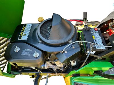 Sale Photo Thumbnail #152: John Deere GT275 Garden Tractor with a Yellow seat, a Mower deck, and Extra Wheel