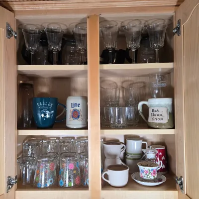 LOT 102: Kitchen Cabinet Lot Including Drinking Glasses. Philadelphia Eagles Mug, Miller Lite Mug, and More