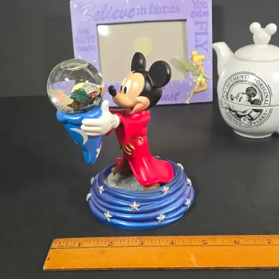 LOT 97: Sorcerer Mickey Mouse "Where Magic Lives" Snow Globe Figurine, Cinderella Wallet, Teapot for One Set, Picture Frame,...