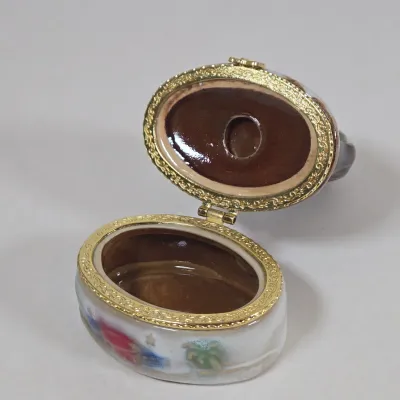 LOT 100: Porcelain Trinket Boxes, Two Clear, Geometric Cut Glass Paperweights, and More