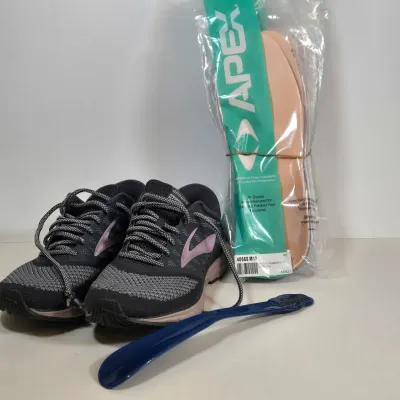 LOT 108: Brooks Women's Revel 'Grey Rose Gold' Running Shoes, Multiple Packs of Apex Shoe Inserts. and Shoe Horn