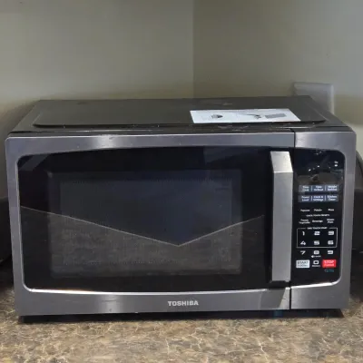LOT 94: Toshiba Countertop Microwave Oven with a Stainless Steel Finish