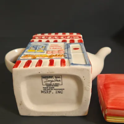 LOT 41: Vintage Novelty Teapot by MSRF Inc. Design Studio and Dogzilla Hand-Painted Ceramic Stackable Teapot and Cup Set