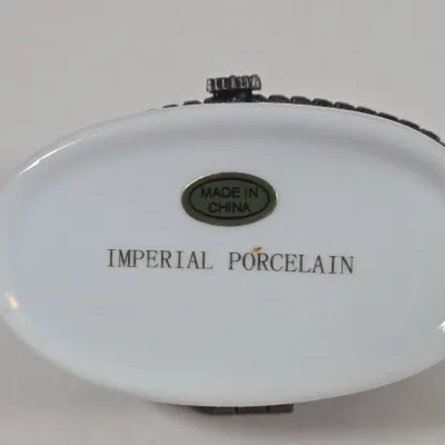 LOT 100: Porcelain Trinket Boxes, Two Clear, Geometric Cut Glass Paperweights, and More