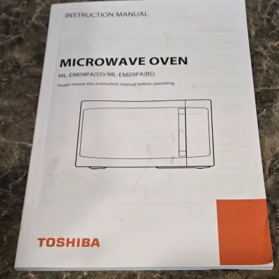 LOT 94: Toshiba Countertop Microwave Oven with a Stainless Steel Finish