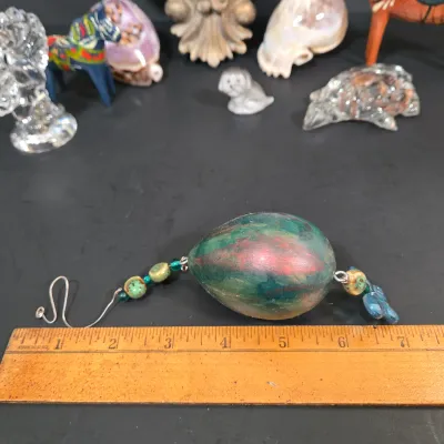 LOT 85: Ornate Wall Mirror, Handmade Hanging Ornament, Clear Glass Dragon & Turtle, Miniature Ceramic Dog, 2 Traditional Wooden Dala...