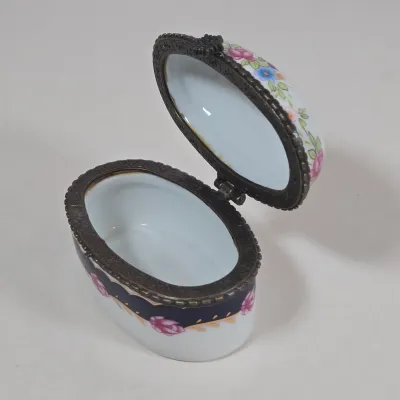 LOT 100: Porcelain Trinket Boxes, Two Clear, Geometric Cut Glass Paperweights, and More