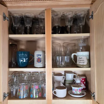 LOT 102: Kitchen Cabinet Lot Including Drinking Glasses. Philadelphia Eagles Mug, Miller Lite Mug, and More