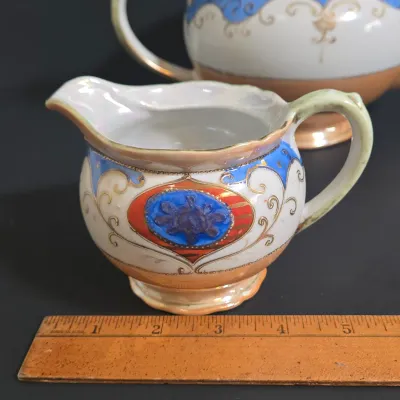 LOT 45: Porcelain Teapot with Basketweave Design and Japanese Lustreware Teapot and Creamer