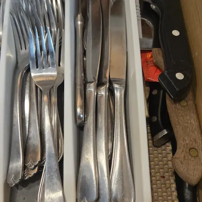 LOT 86: Multiple Kitchen Drawers Lot Including Flatware, Utensils, and More